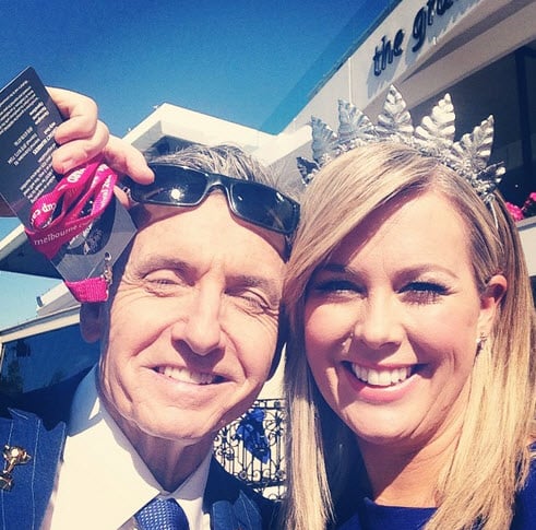 Smiling man and woman wearing festive accessories.