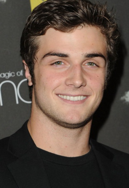 Smiling man in a black shirt.