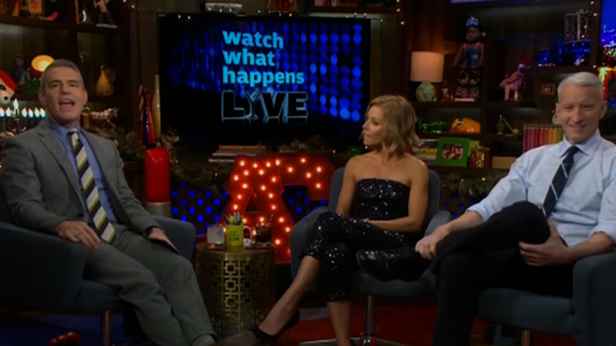 TV show hosts sitting and talking together.