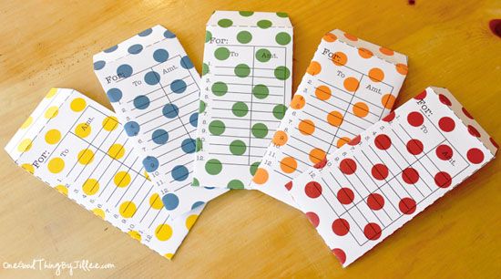Colorful polka dot envelopes on wooden table.