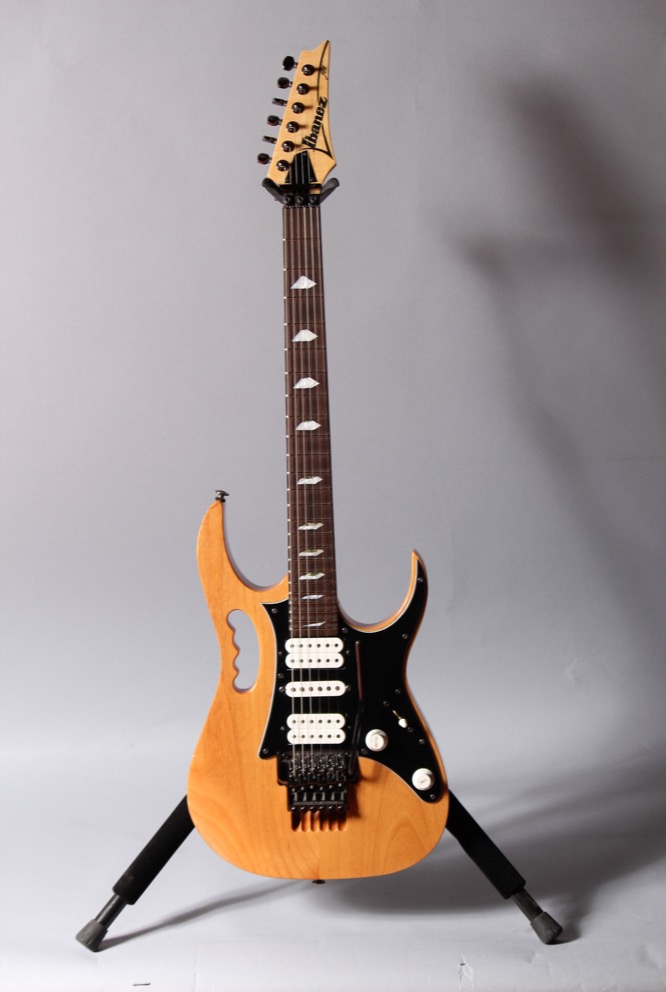 Electric guitar on a stand.