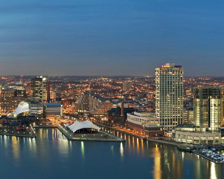 City skyline with waterfront at dusk.
