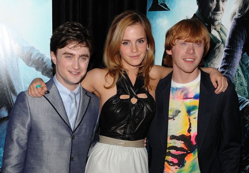 Three people posing at a movie event.