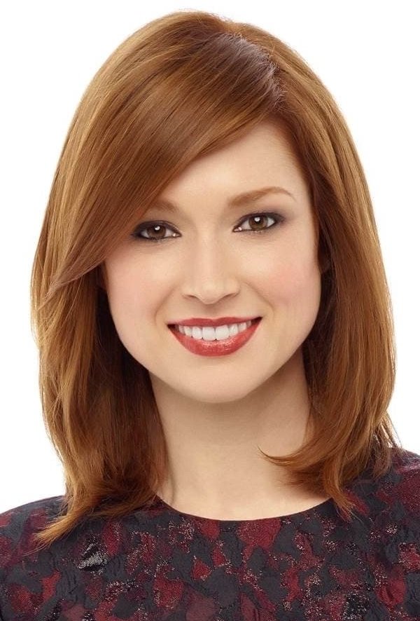 Smiling woman with shoulder-length red hair.