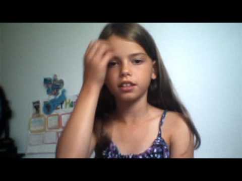 Girl with long hair touching her face.