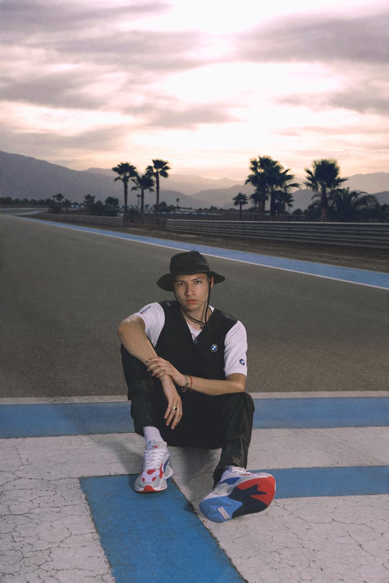 Person sitting on road with palm trees.