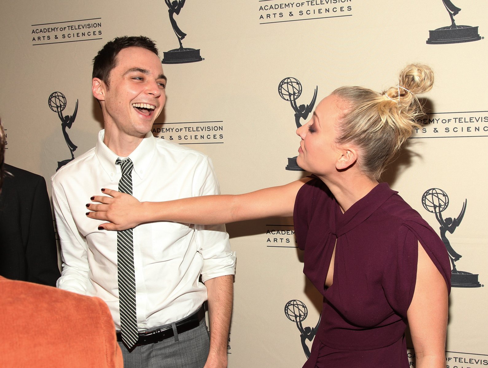 Two people laughing at an event.