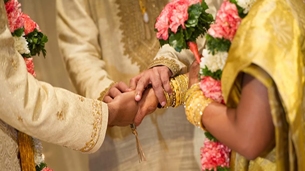 Traditional Indian wedding ceremony hand-holding.