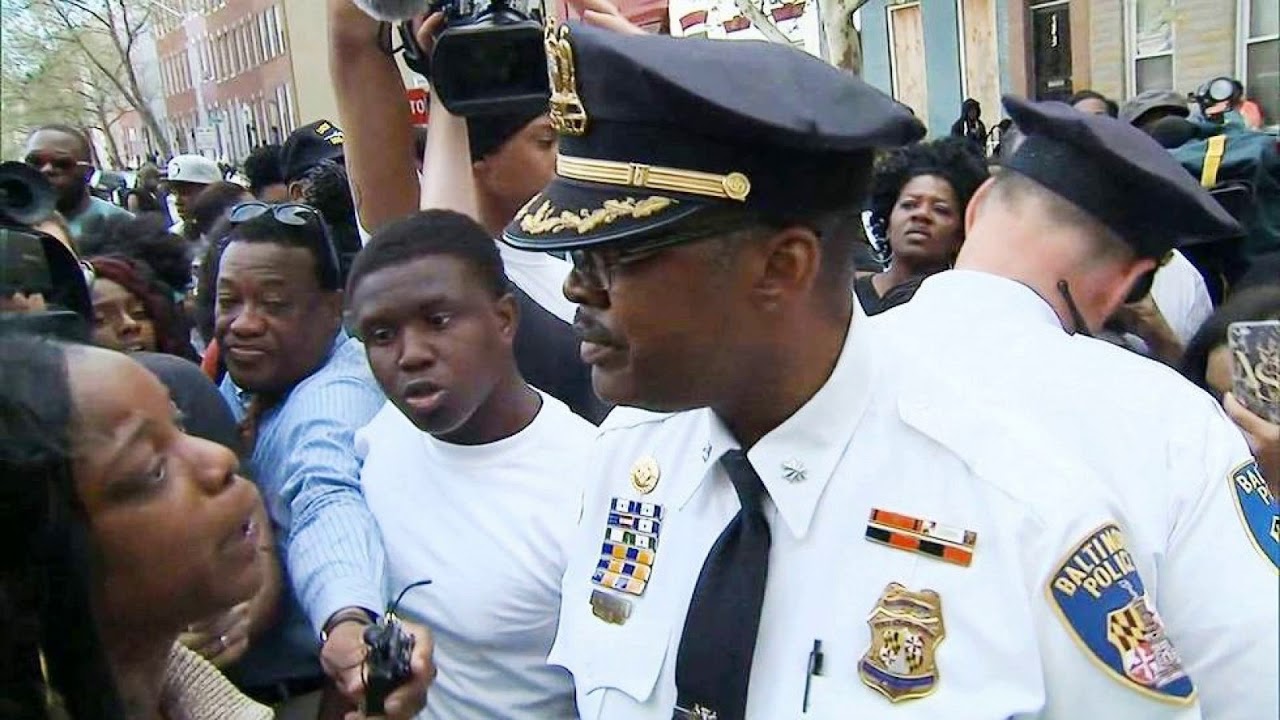 Police and crowd in street confrontation.