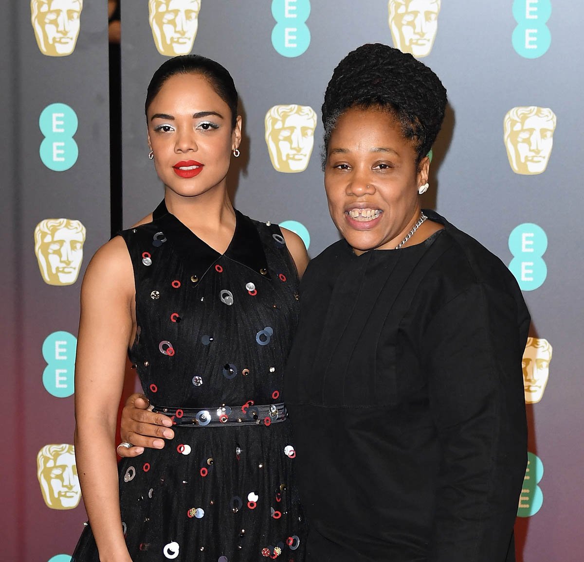 Two people posing at an awards event.