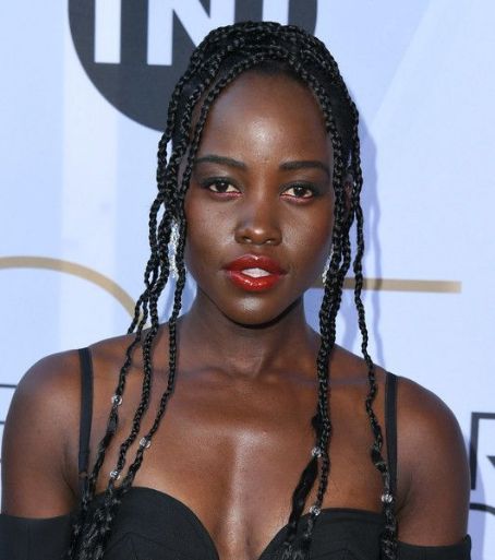 Woman with braided hair and red lipstick.
